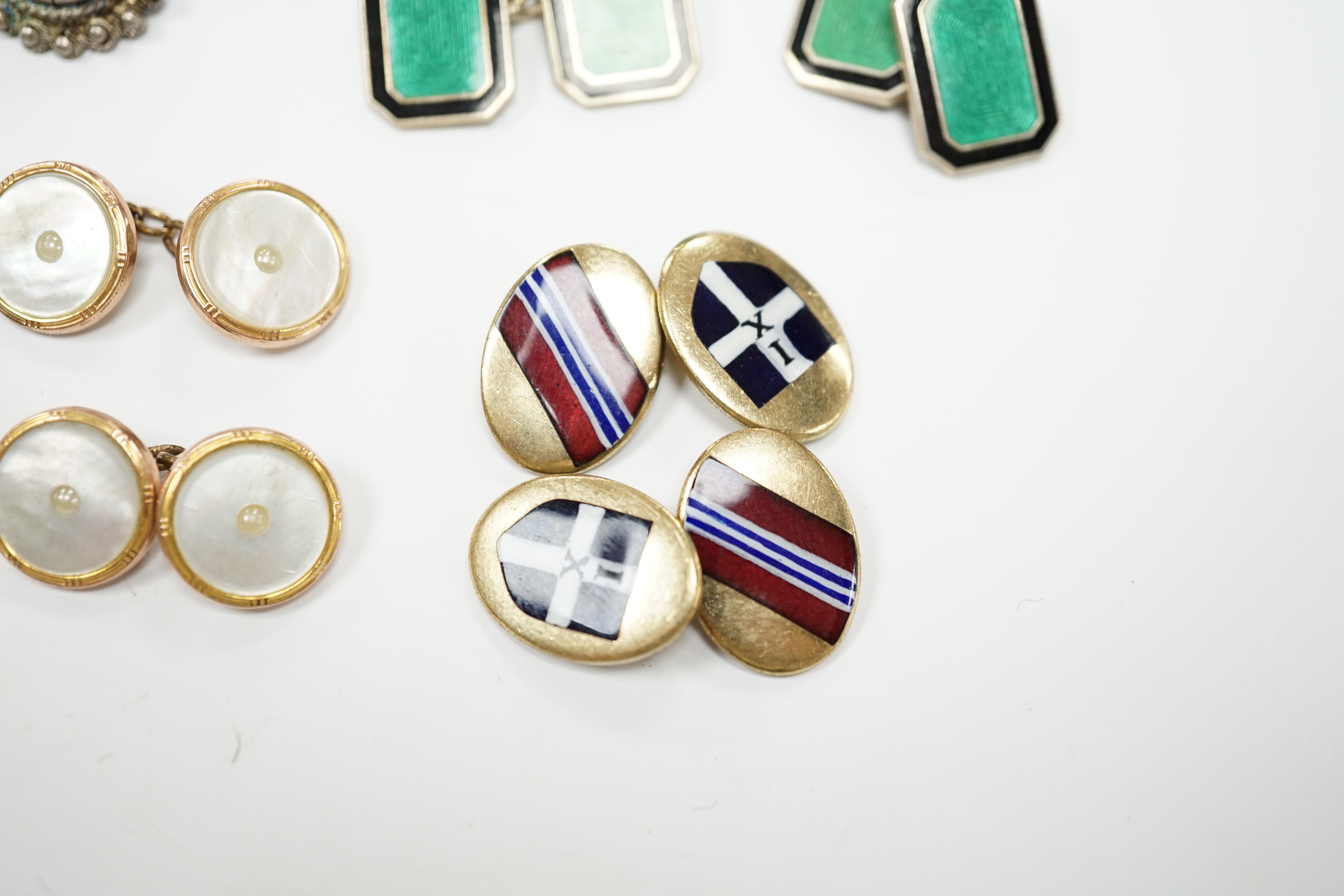 Four assorted pairs of cufflinks including silver and two coloured enamel.